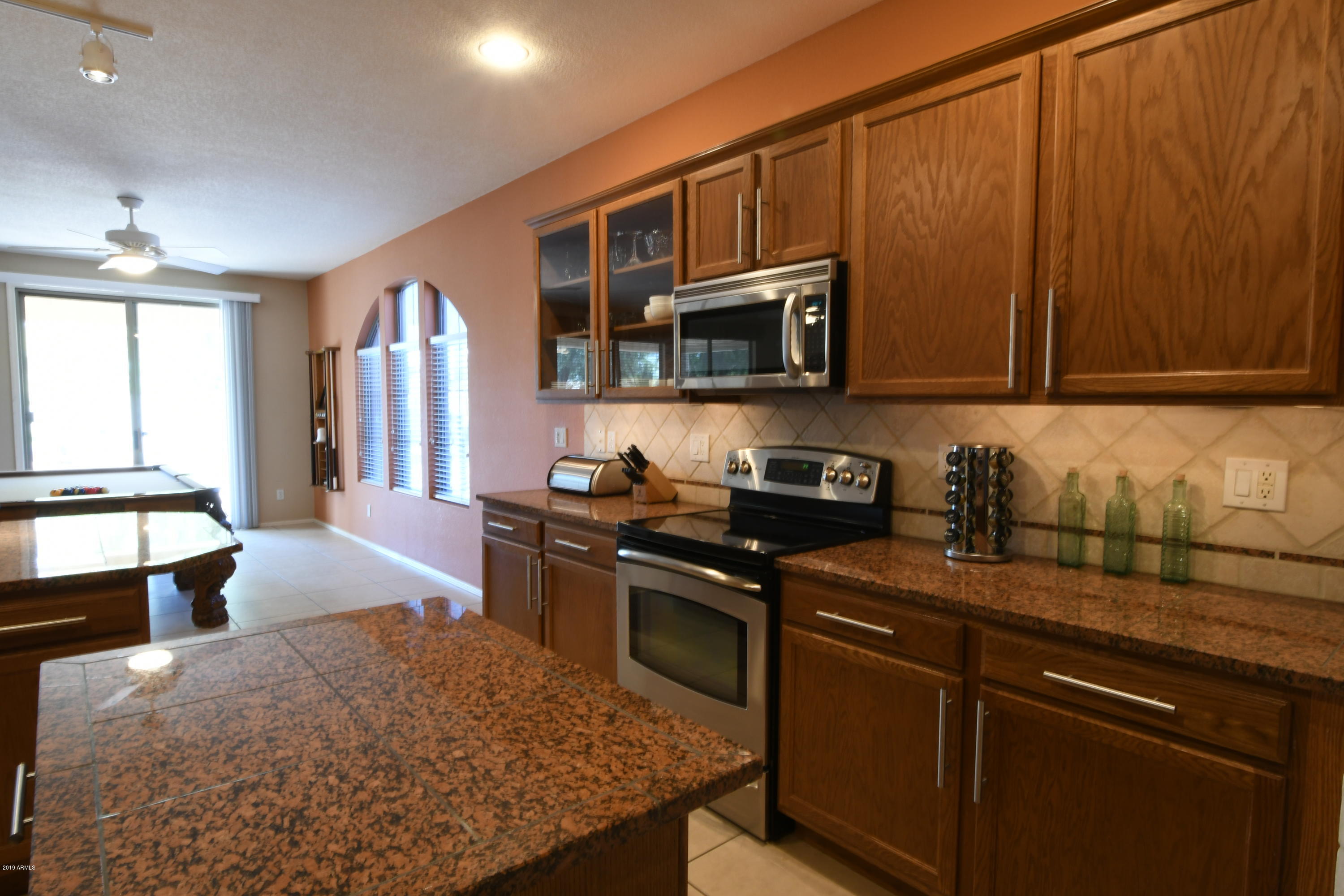 2226 West Carson Road Phoenix, AZ 85041 - Photo 9 of 29 a kitchen with stainless steel appliances granite countertop a stove a sink dishwasher and microwave oven