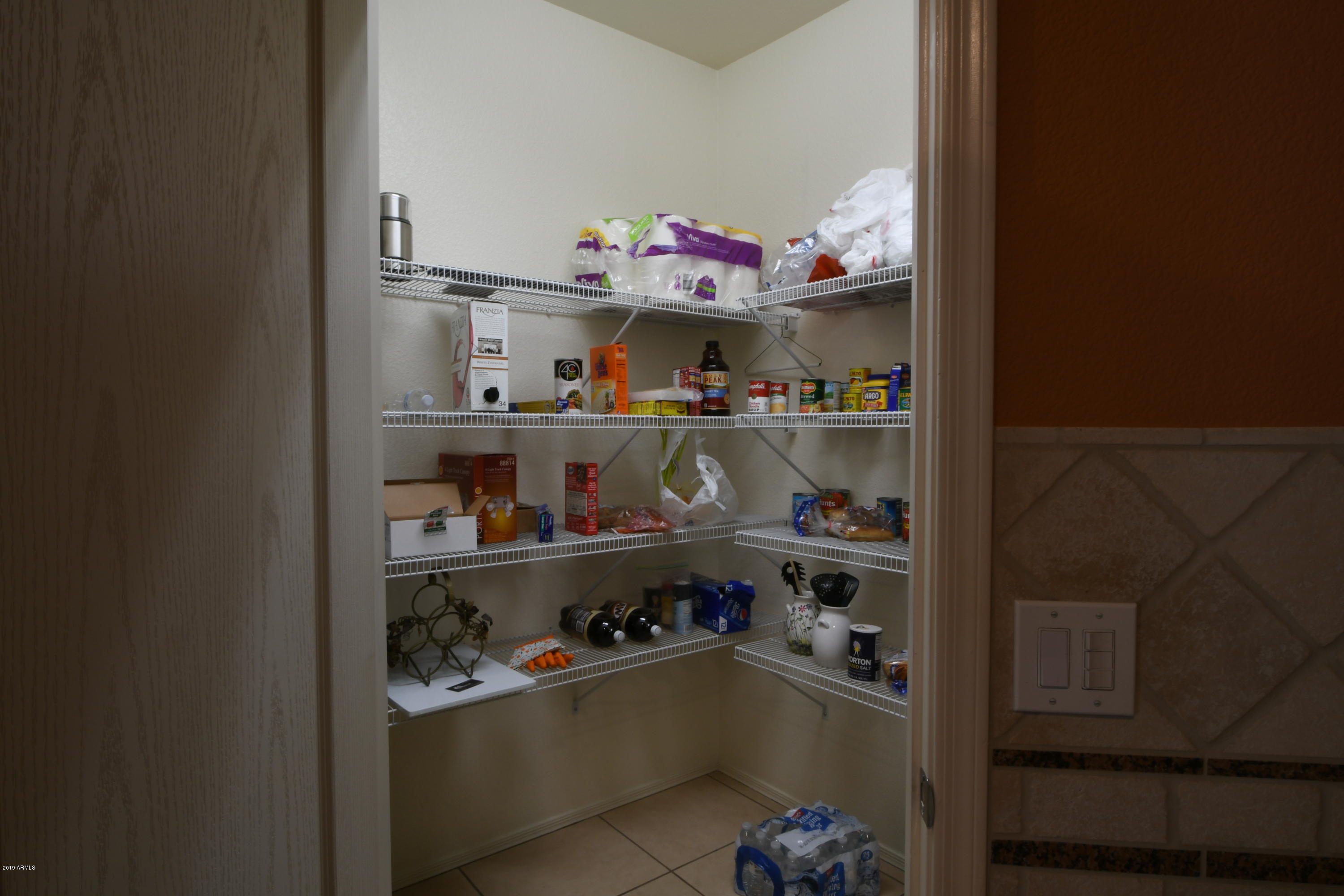 2226 West Carson Road Phoenix, AZ 85041 - Photo 10 of 29 a room with food items with white walls