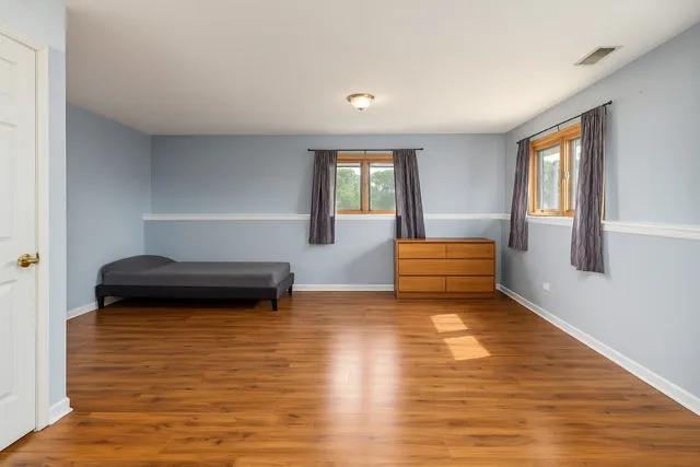 a view of a room with wooden floor and window