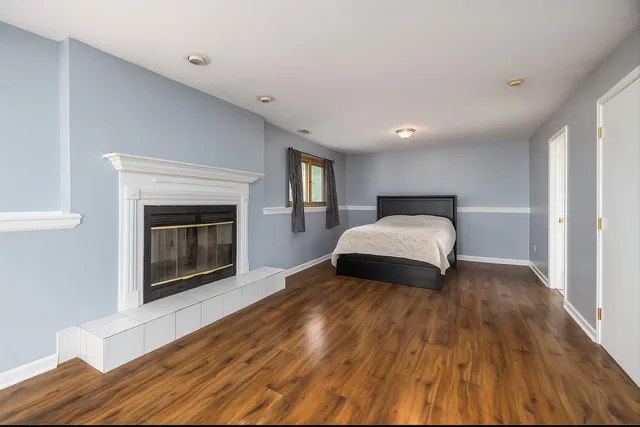 a bedroom with a bed and a fireplace