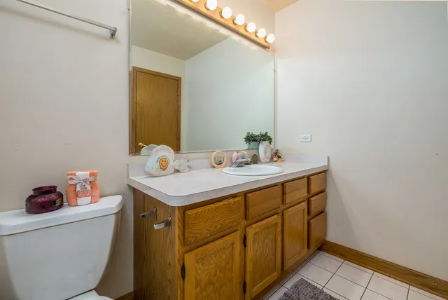 a bathroom with a sink toilet and a mirror