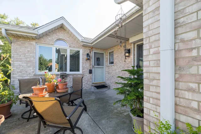 a view of a patio with table and chairs and potted plants