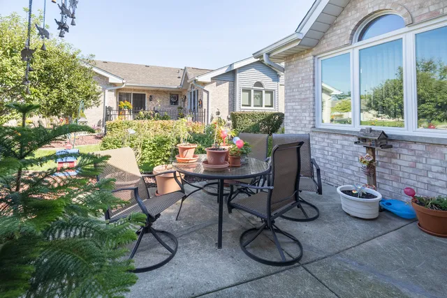 a backyard of a house with table and chairs