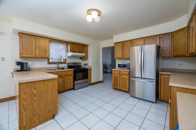 a kitchen with a refrigerator sink and microwave