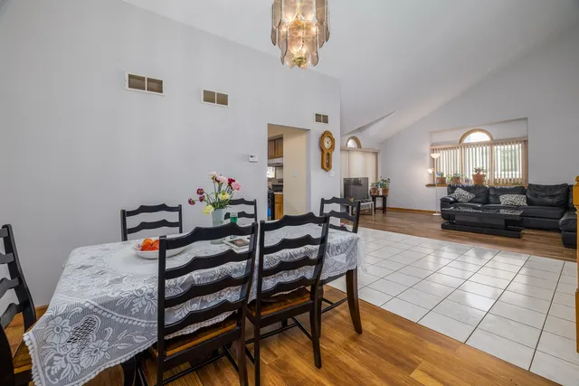 a living room with furniture and a dining table