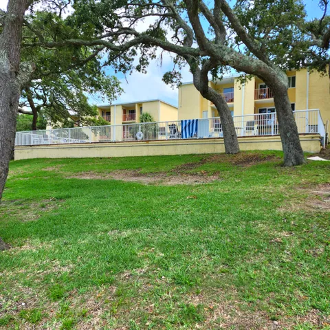 a view of house with a yard