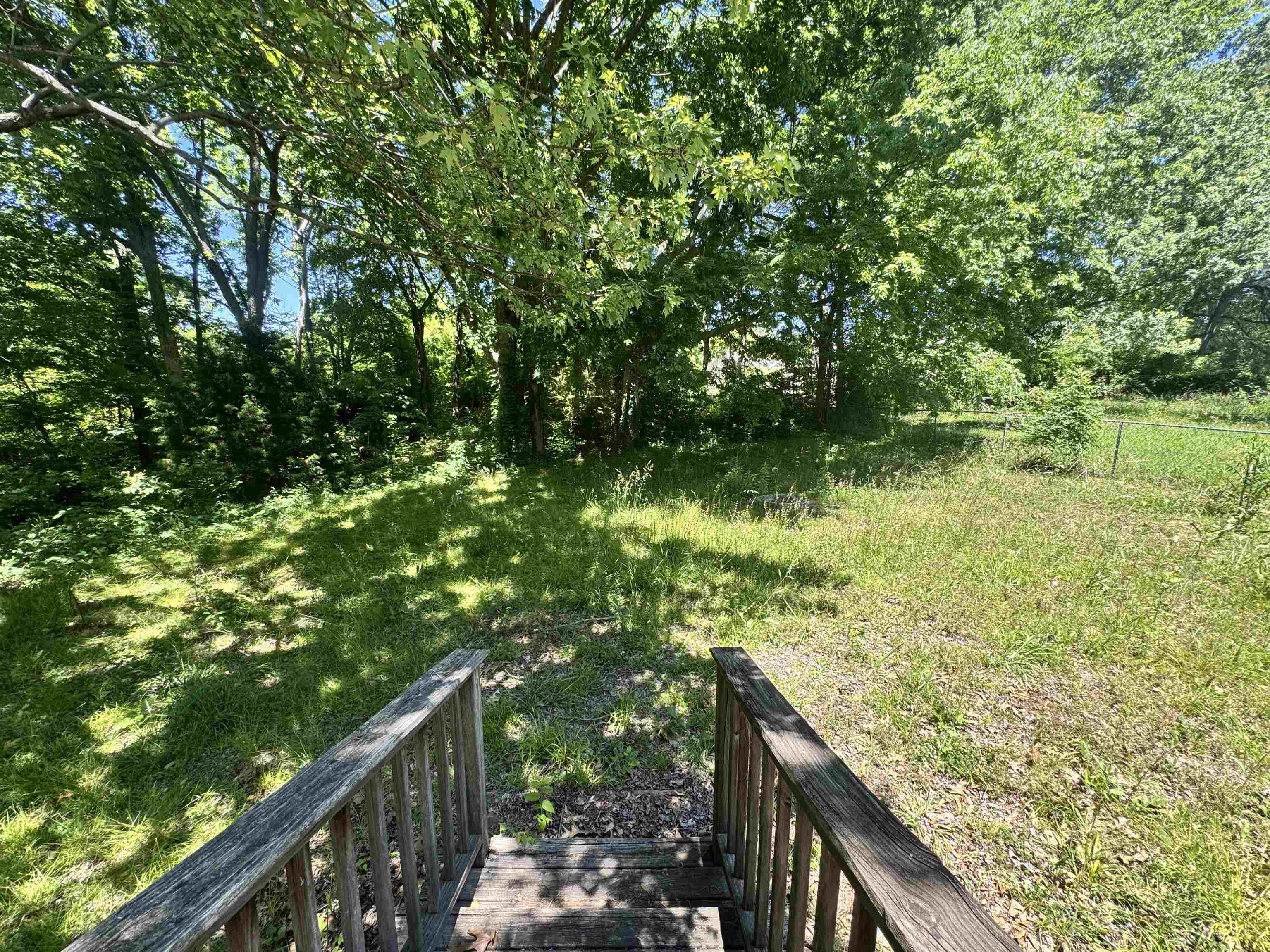 4712 Drummonds Road Drummonds, TN 38023 - Photo 34 of 38 Wood deck with baluster railing overlooking a spacious natural yard with established trees