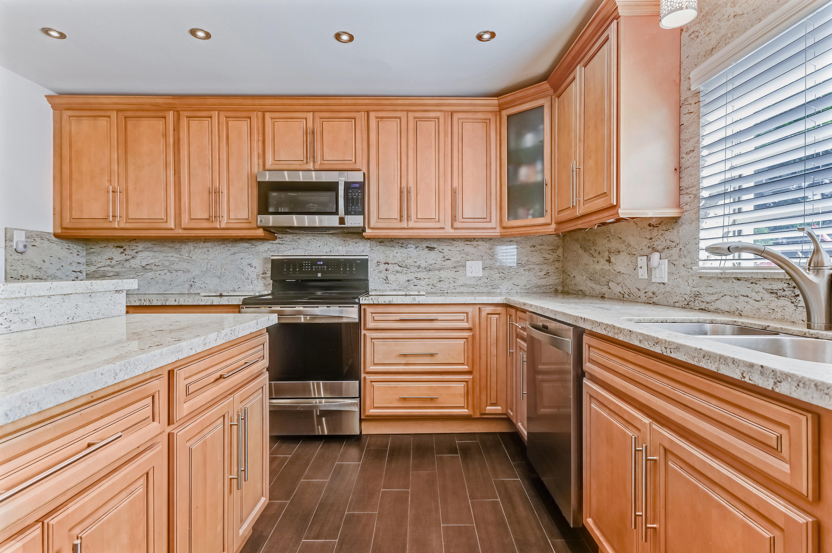 9300 Vista Del Lago, Unit 6B Boca Raton, FL 33428 - Photo 11 of 22 a kitchen with a sink a stove and cabinets
