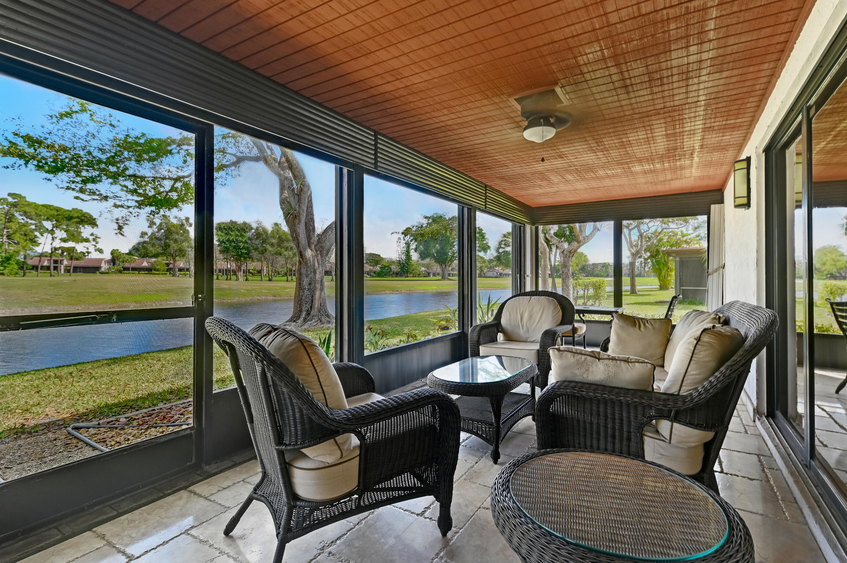9300 Vista Del Lago, Unit 6B Boca Raton, FL 33428 - Photo 19 of 22 a dining room with furniture a rug and a large window