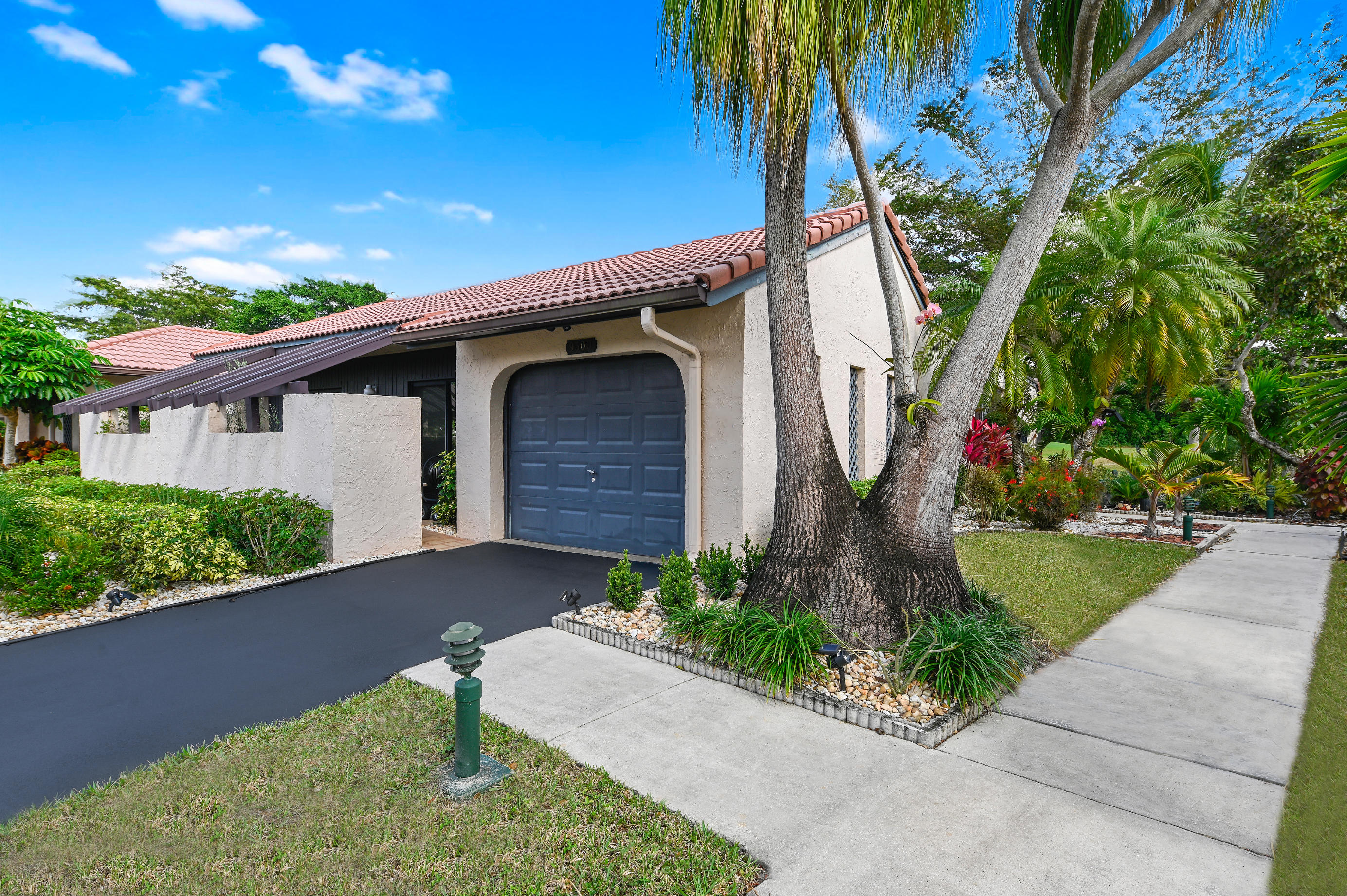 9300 Vista Del Lago, Unit 6B Boca Raton, FL 33428 - Photo 2 of 22 a front view of a house with garden