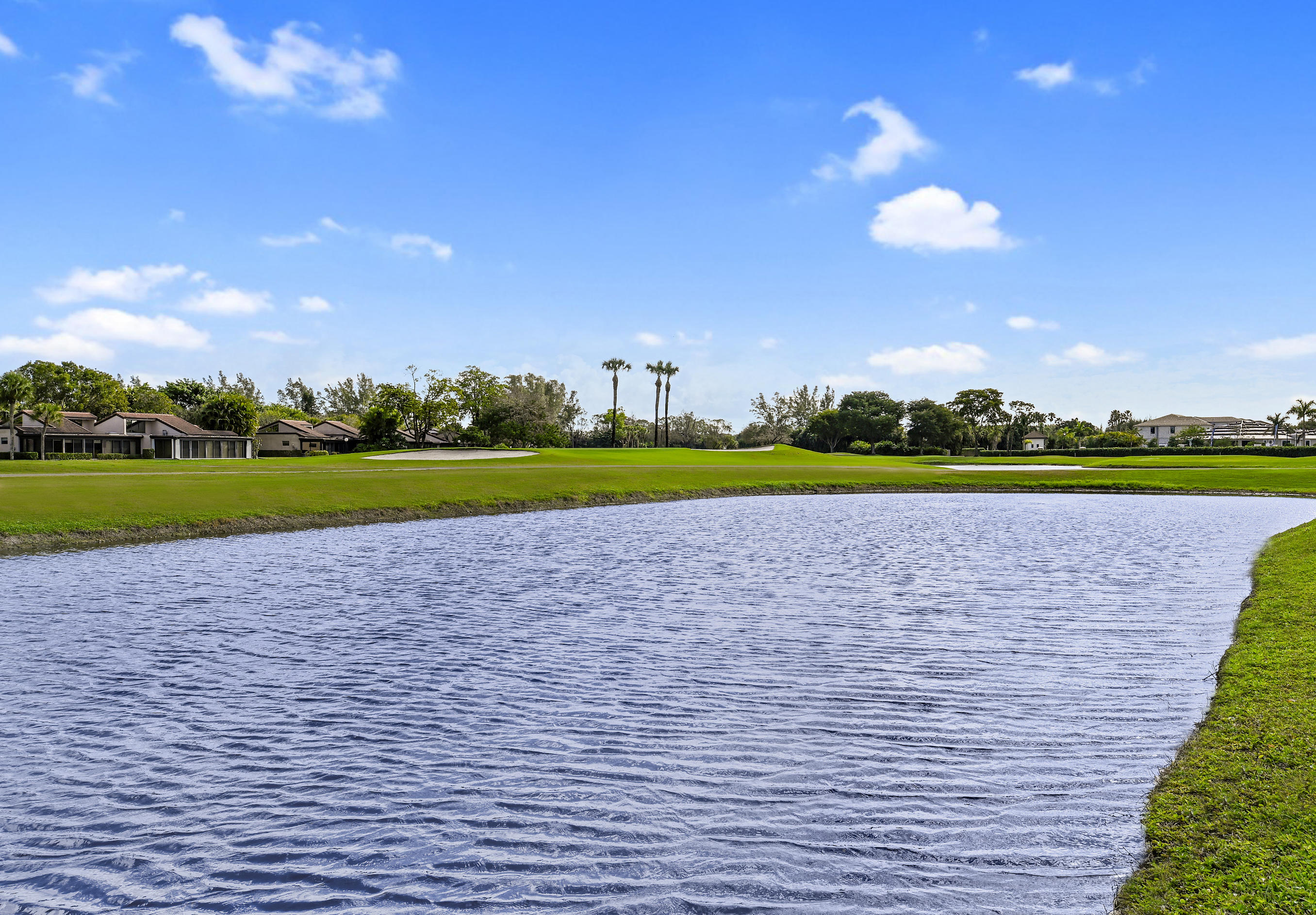 9300 Vista Del Lago, Unit 6B Boca Raton, FL 33428 - Photo 22 of 22 a view of a fountain in front of a house with a big yard
