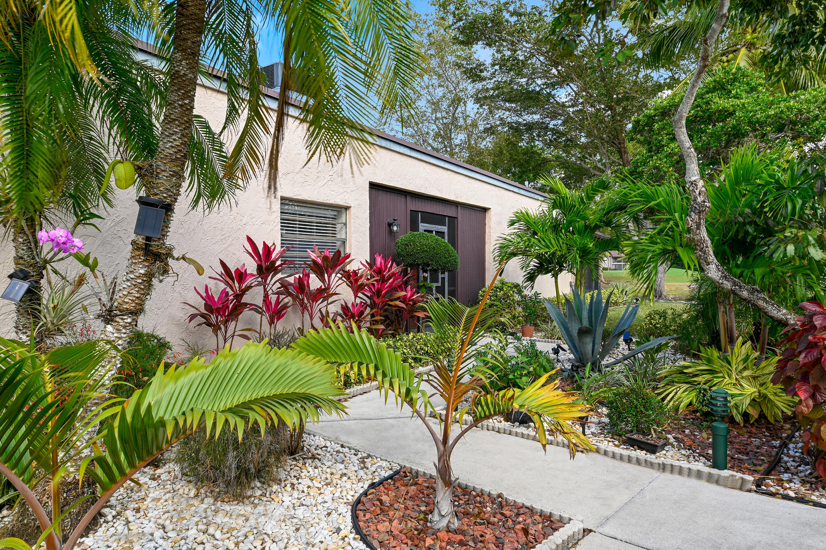 9300 Vista Del Lago, Unit 6B Boca Raton, FL 33428 - Photo 3 of 22 a vase of flowers sitting on a wooden floor