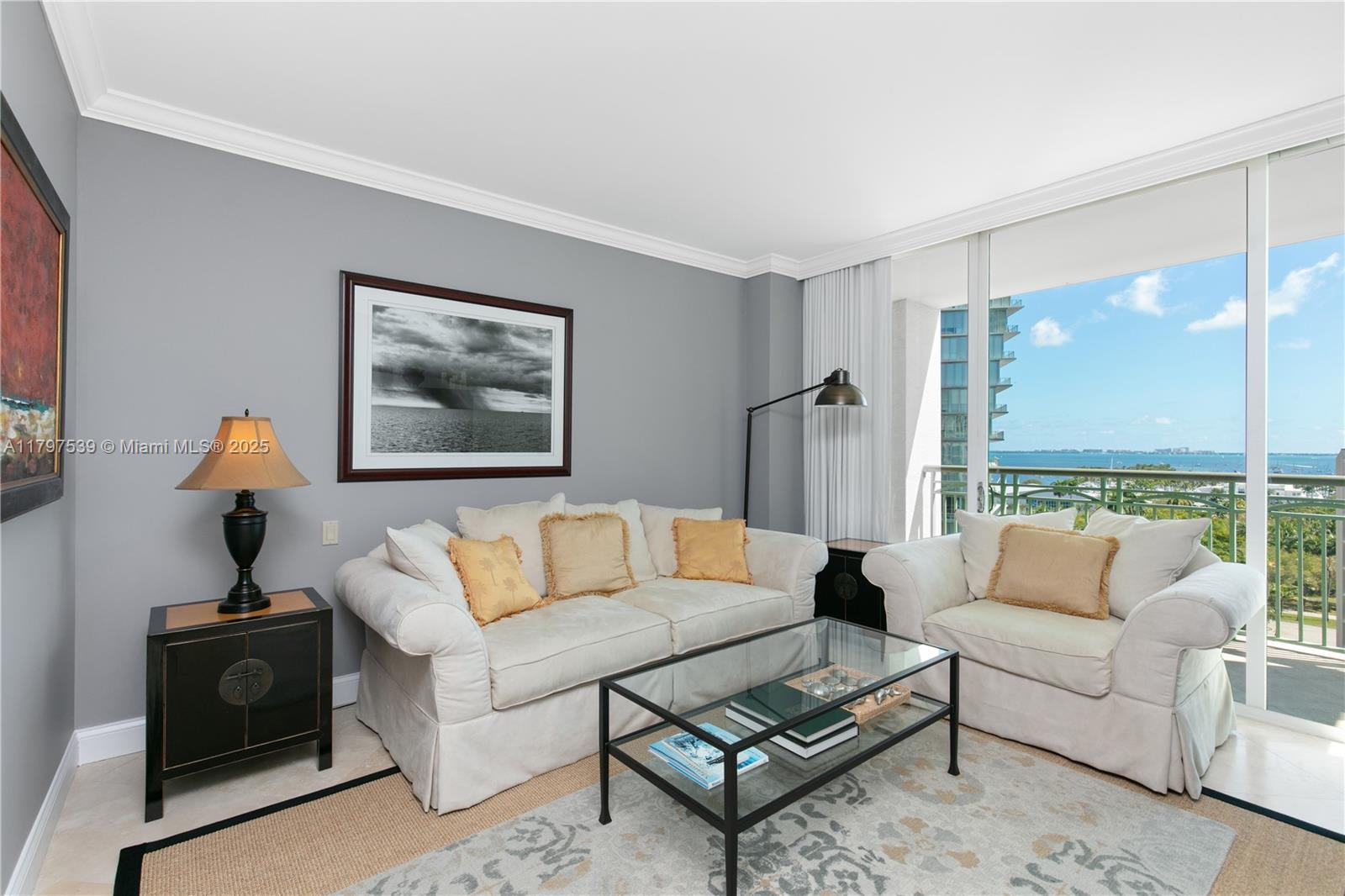 3350 Southwest 27th Avenue, Unit 902 Miami, FL 33133 - Photo 13 of 40 a living room with furniture a rug and a large window