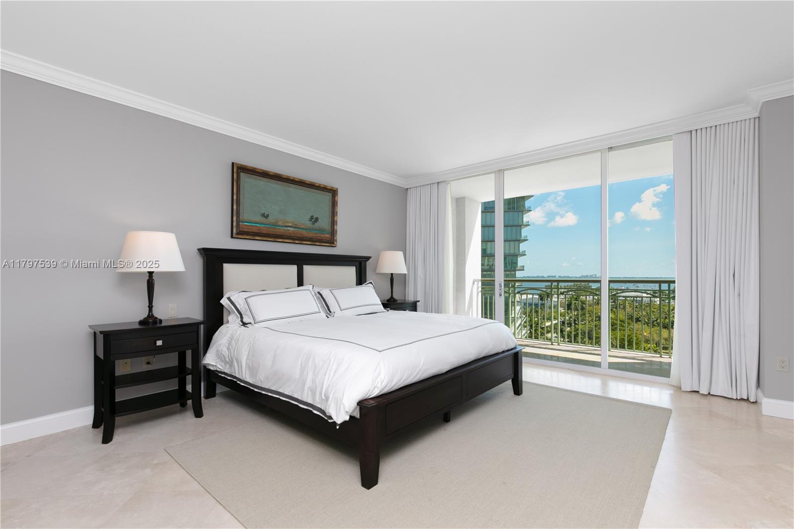 3350 Southwest 27th Avenue, Unit 902 Miami, FL 33133 - Photo 14 of 40 a bedroom with a bed lamp and a large window