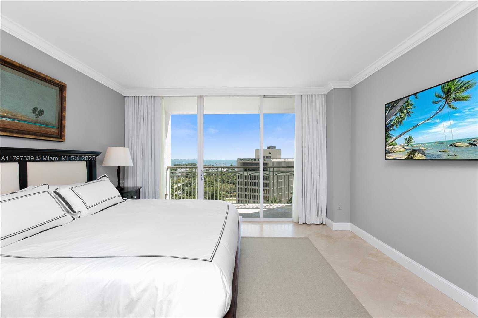 3350 Southwest 27th Avenue, Unit 902 Miami, FL 33133 - Photo 15 of 40 a bedroom with a large bed and a flat tv screen on dresser