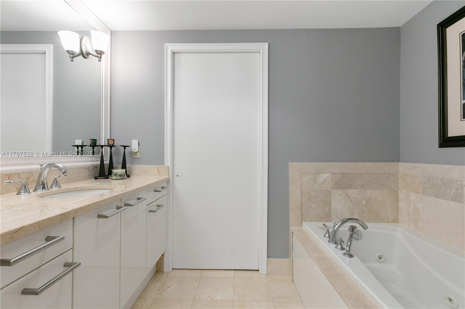 3350 Southwest 27th Avenue, Unit 902 Miami, FL 33133 - Photo 16 of 40 a bathroom with a tub sink and mirror