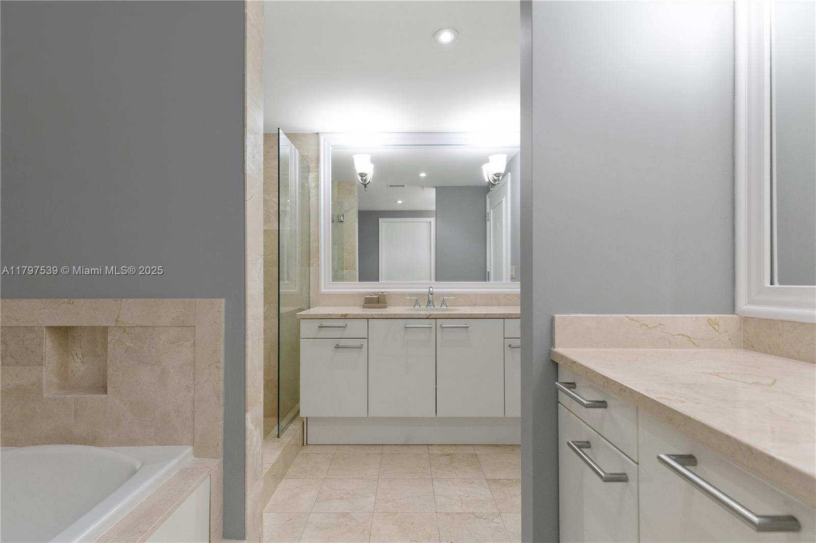 3350 Southwest 27th Avenue, Unit 902 Miami, FL 33133 - Photo 17 of 40 a bathroom with a sink a vanity and a mirror