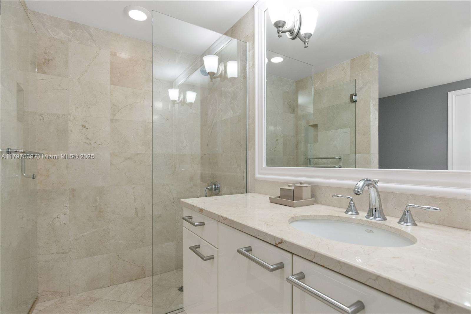 3350 Southwest 27th Avenue, Unit 902 Miami, FL 33133 - Photo 19 of 40 a bathroom with a sink double vanity and a mirror