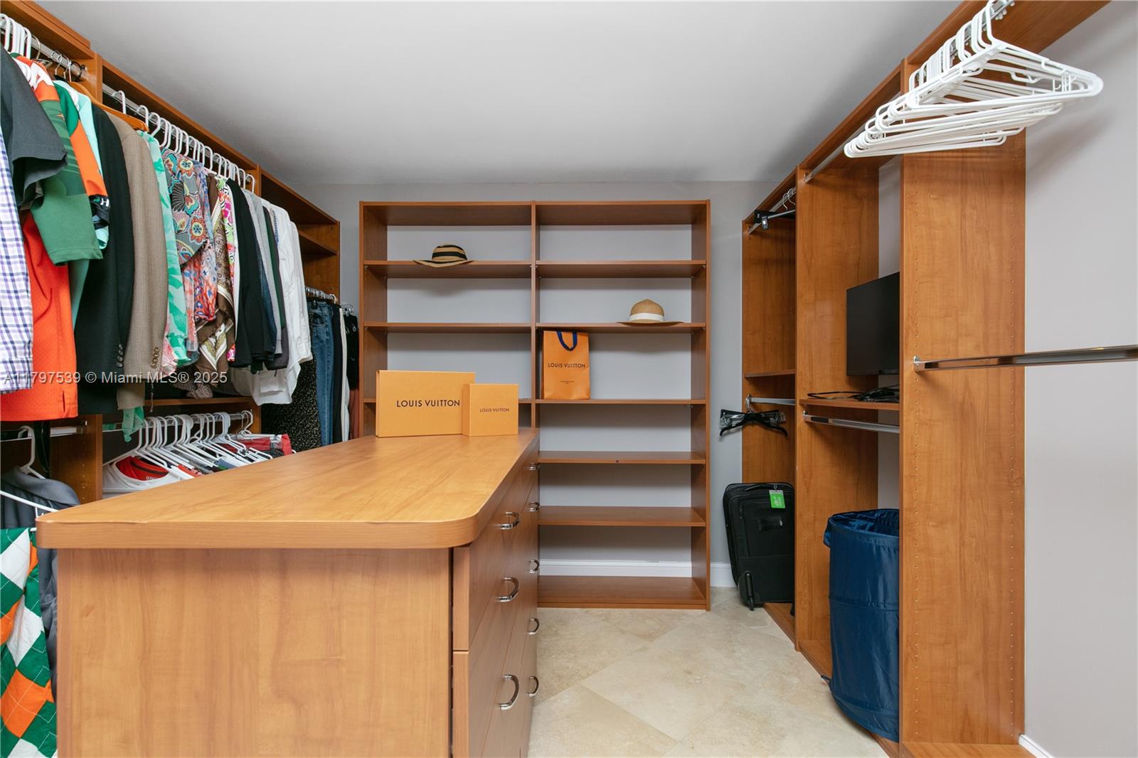 3350 Southwest 27th Avenue, Unit 902 Miami, FL 33133 - Photo 20 of 40 a view of walk in closet with clothes and shoes