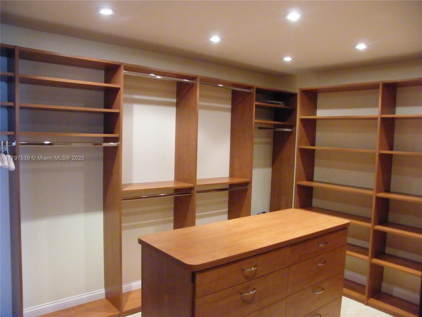 3350 Southwest 27th Avenue, Unit 902 Miami, FL 33133 - Photo 21 of 40 a kitchen with kitchen island a counter top space and refrigerator