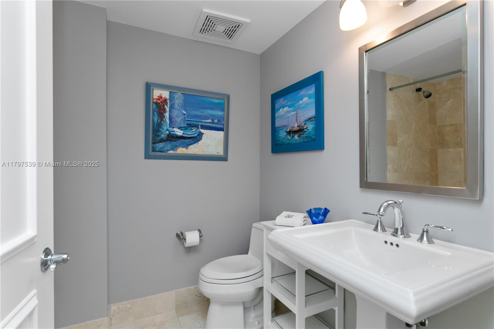 3350 Southwest 27th Avenue, Unit 902 Miami, FL 33133 - Photo 25 of 40 a bathroom with a sink and a toilet