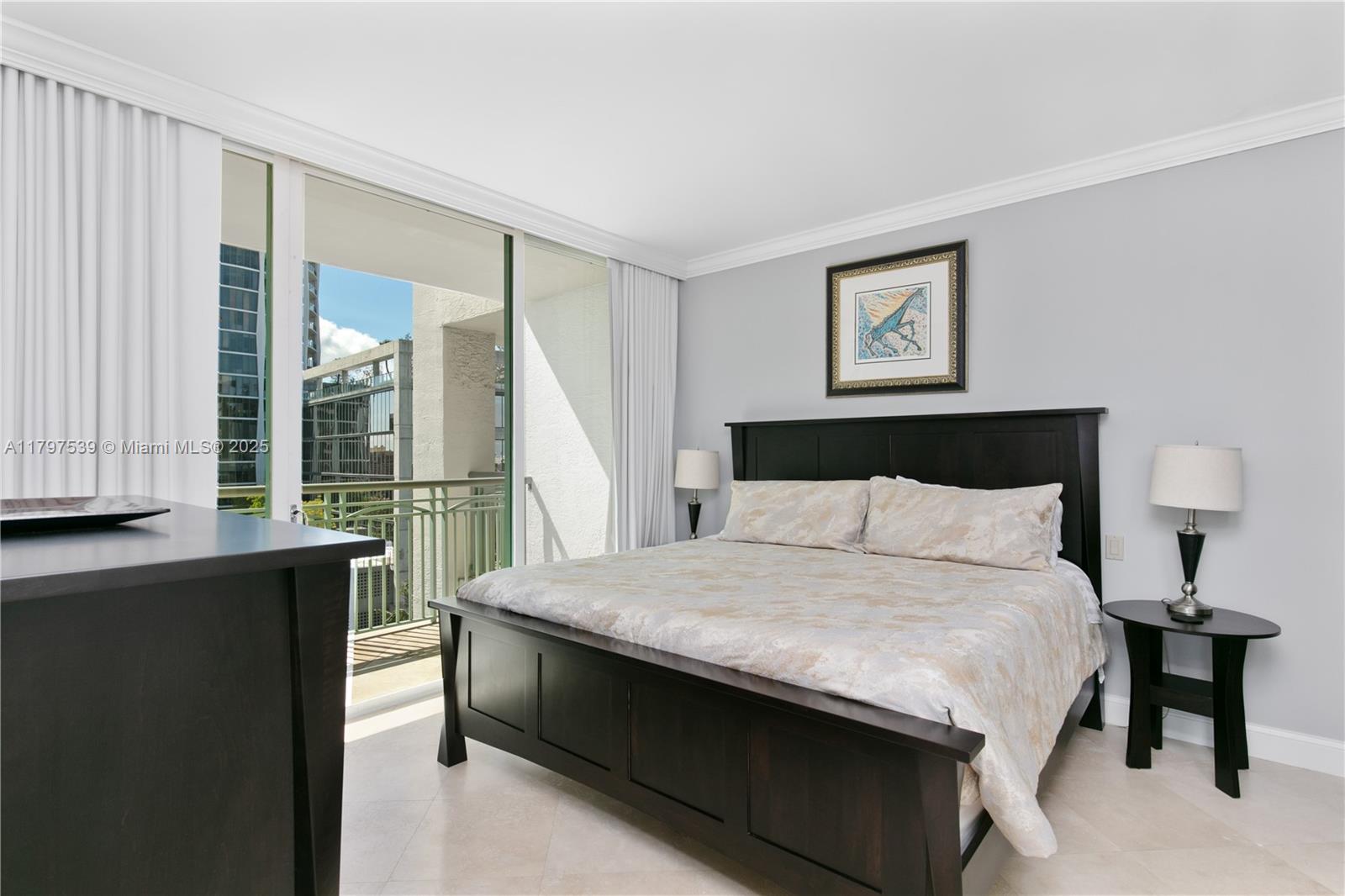 3350 Southwest 27th Avenue, Unit 902 Miami, FL 33133 - Photo 28 of 40 a large bed sitting in a bedroom next to a window