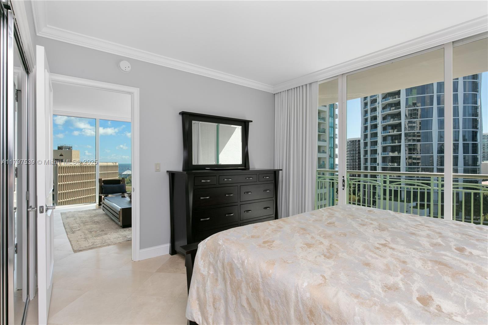 3350 Southwest 27th Avenue, Unit 902 Miami, FL 33133 - Photo 29 of 40 a bedroom with a bed and a dresser