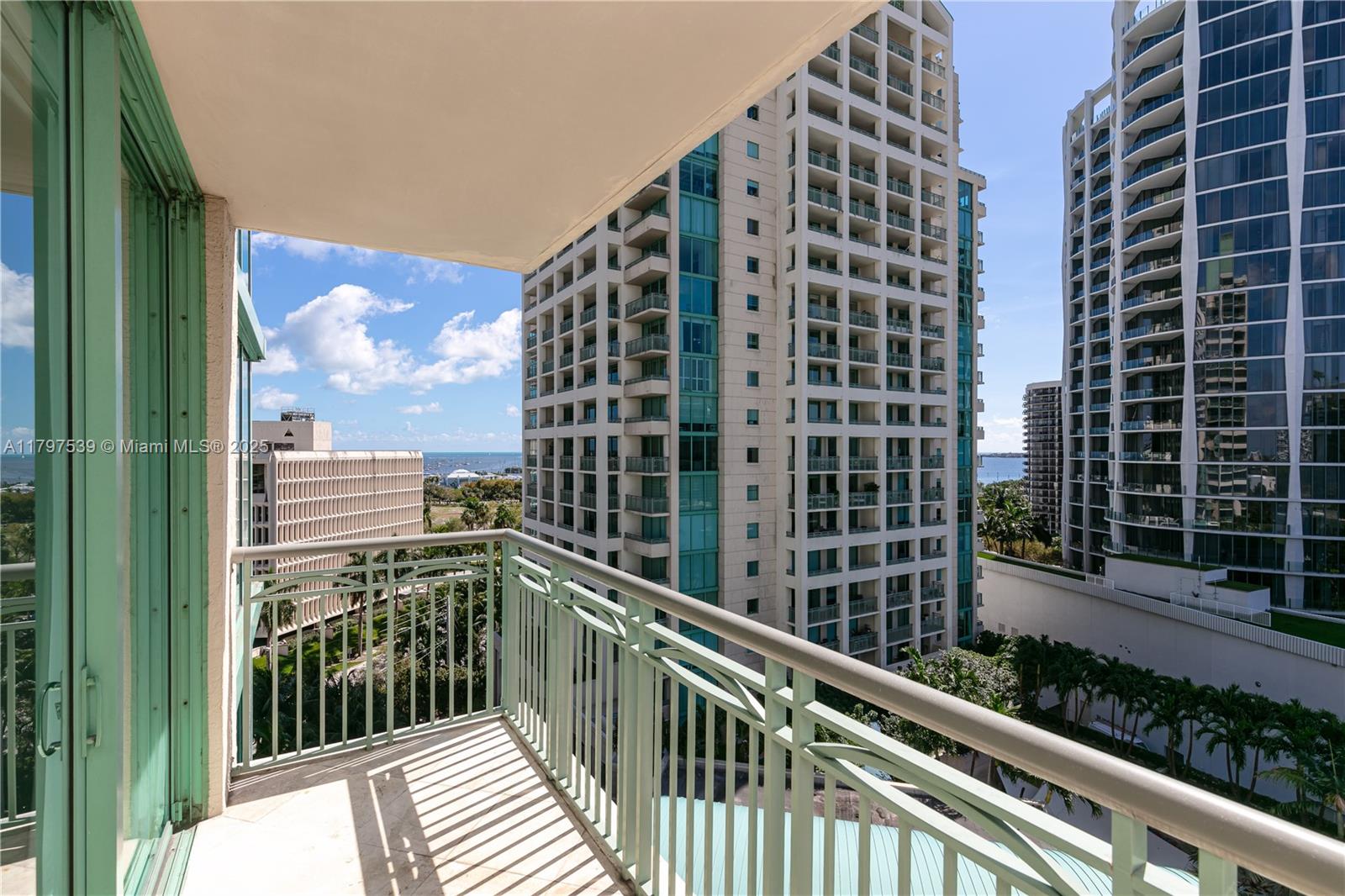 3350 Southwest 27th Avenue, Unit 902 Miami, FL 33133 - Photo 31 of 40 a view of a balcony with a floor to ceiling window and wooden fence