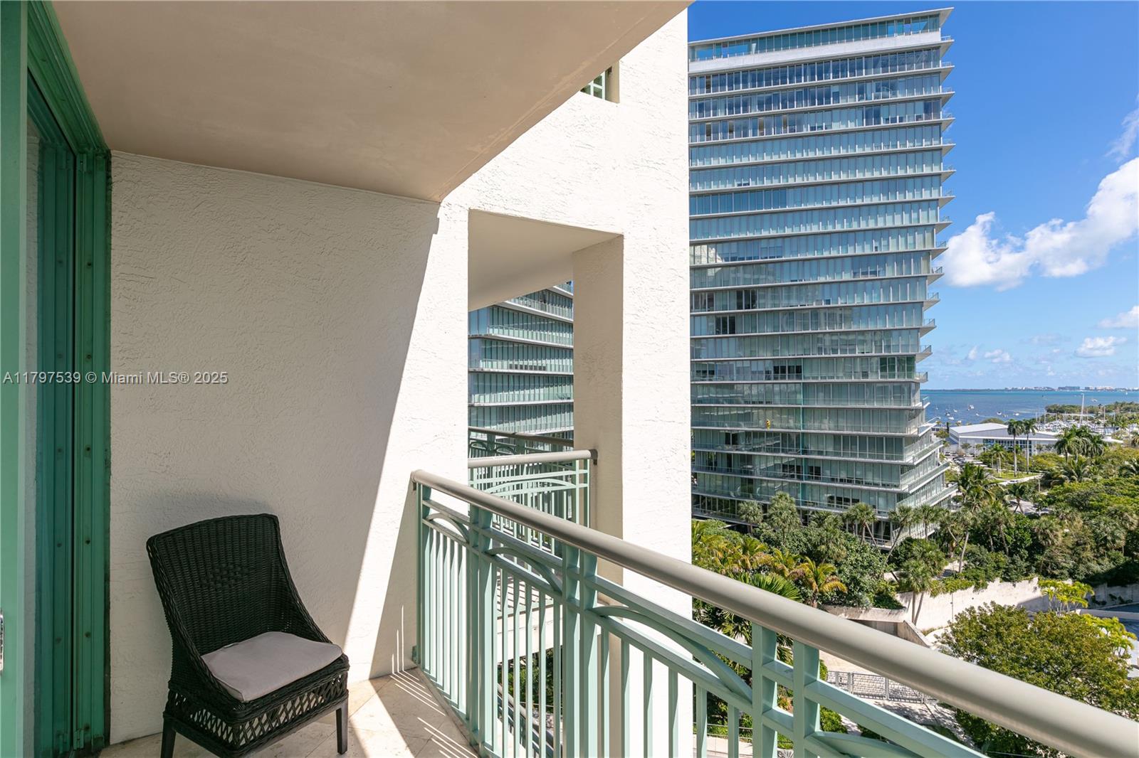 3350 Southwest 27th Avenue, Unit 902 Miami, FL 33133 - Photo 38 of 40 a view of a chair and table in the balcony