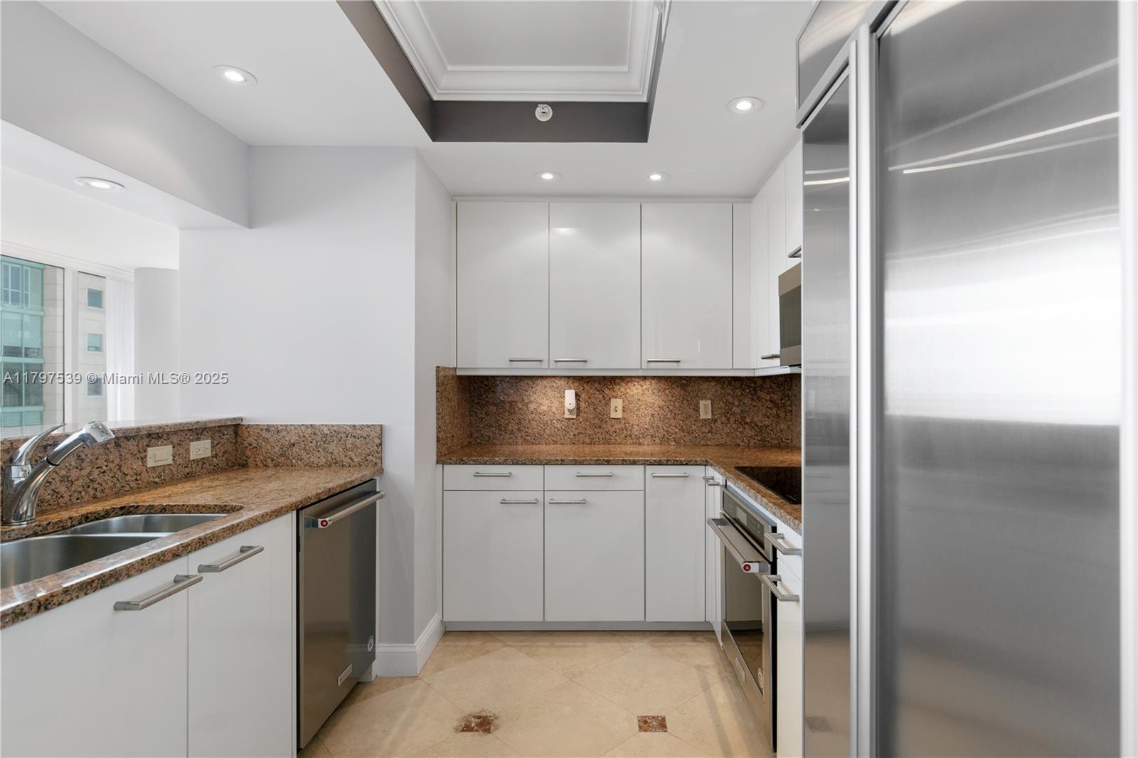 3350 Southwest 27th Avenue, Unit 902 Miami, FL 33133 - Photo 10 of 40 a kitchen that has a sink and a stove in it