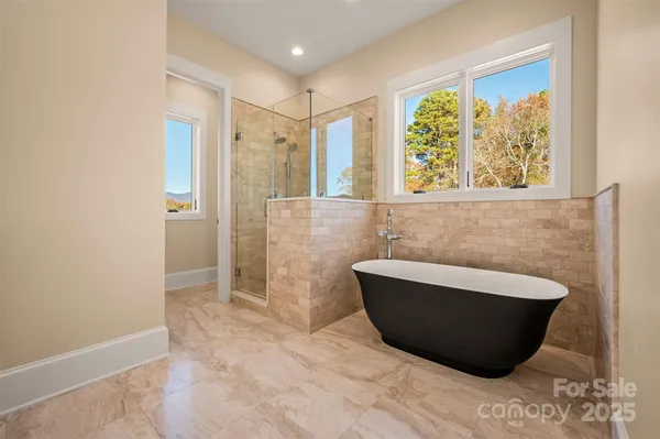 a bathroom with a granite countertop sink a toilet and shower