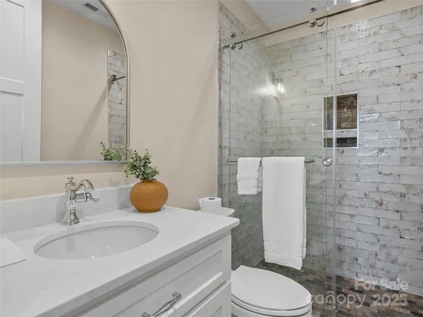 a view of a hallway with wooden floor and entryway