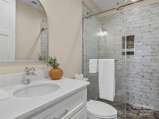 a view of a hallway with wooden floor and entryway