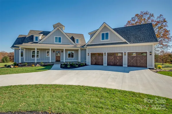 a living room with furniture a fireplace and a chandelier