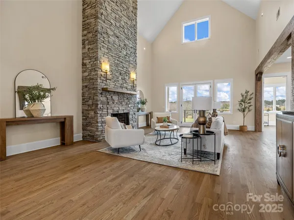a living room with furniture kitchen view and a table