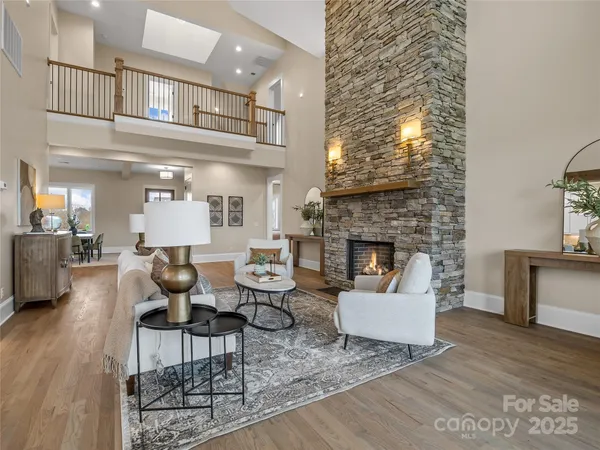 a kitchen with kitchen island granite countertop a table chairs refrigerator and microwave