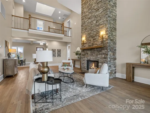 a kitchen with kitchen island granite countertop a table chairs refrigerator and microwave