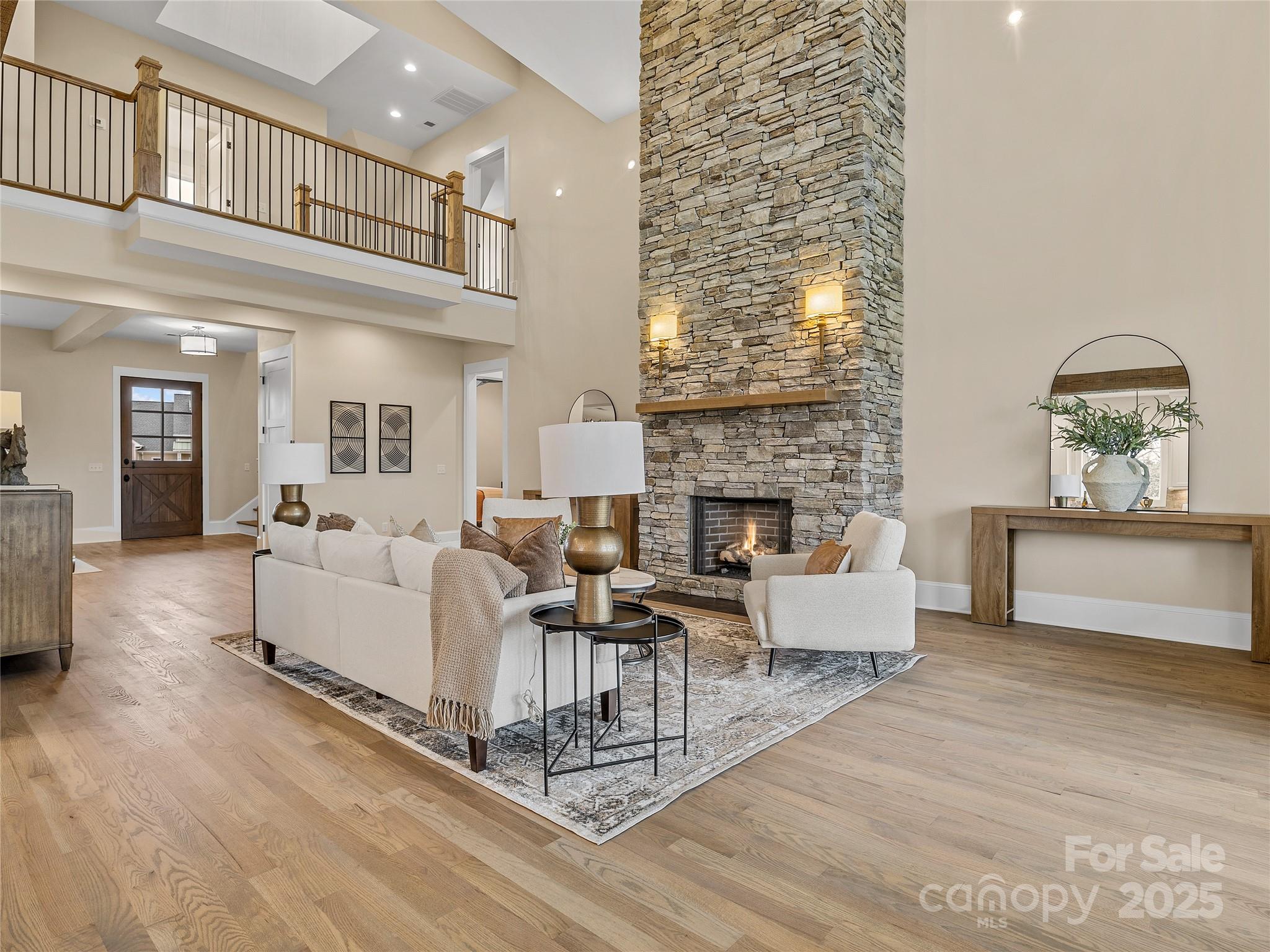 297 Mountain Meadows Lane, Unit 7 Tryon, NC 28782 - Photo 8 of 44 a living room with furniture a fireplace and a chandelier