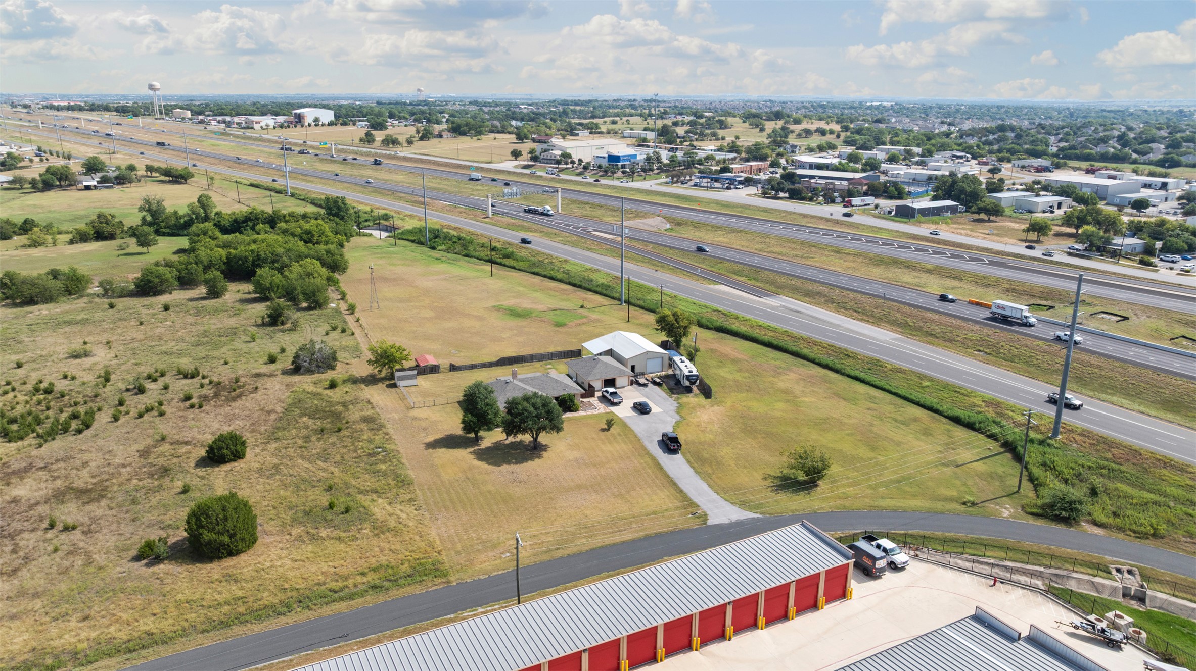1512 Panther Loop Pflugerville, TX 78660 - Photo 39 of 40 Vast land offering a residential dwelling, a warehouse, and storage units, positioned for convenient highway access.