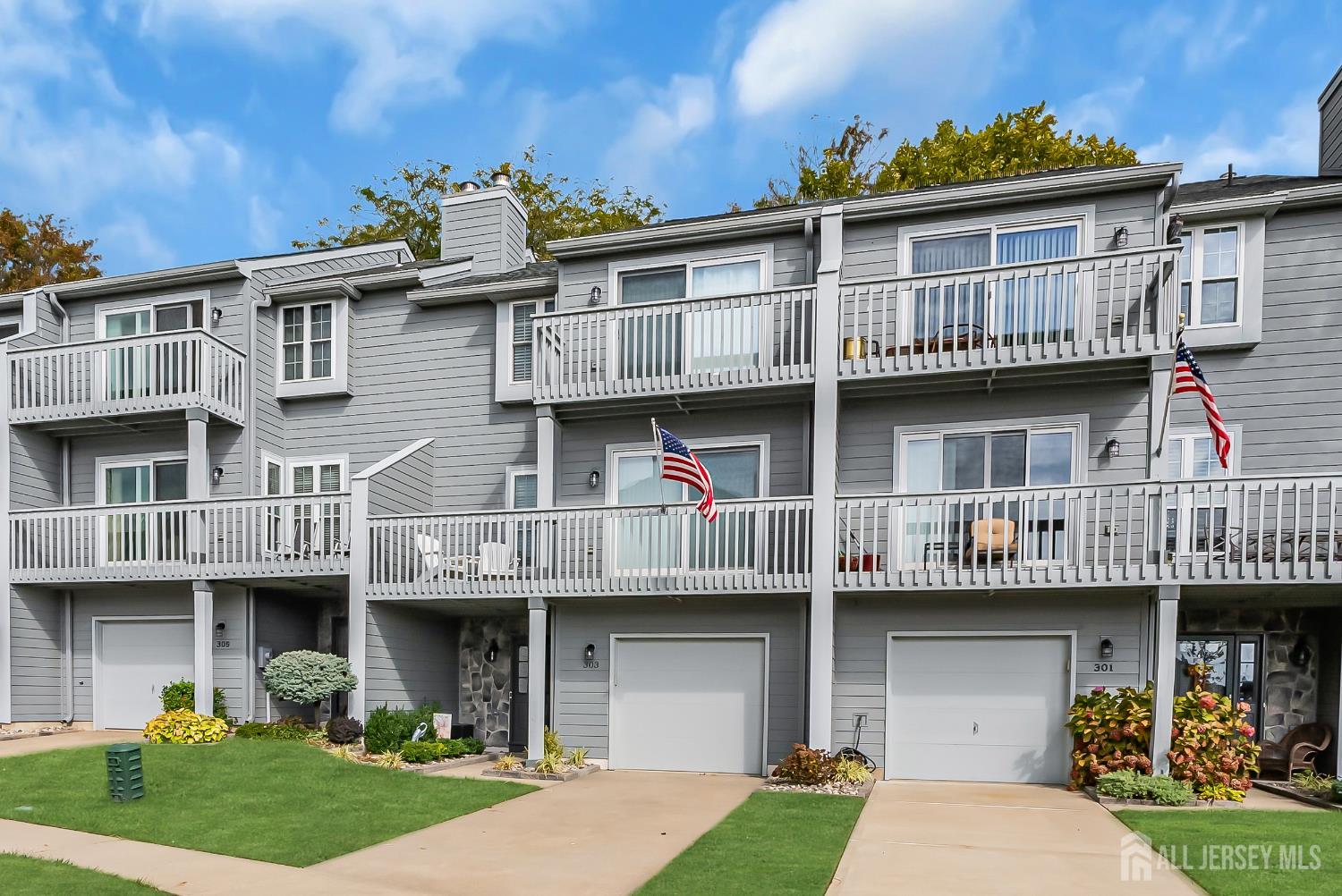a view of a big house with many windows and a yard