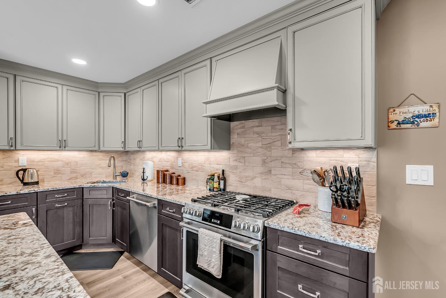 303 Spinnaker Way Neptune, NJ 07753 - Photo 27 of 54 a kitchen with stainless steel appliances granite countertop a sink stove and cabinets