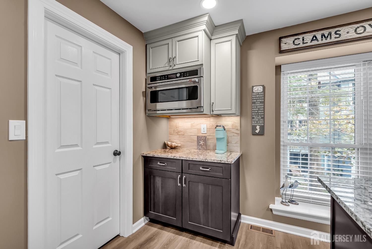 303 Spinnaker Way Neptune, NJ 07753 - Photo 28 of 54 a kitchen with granite countertop a refrigerator and cabinets