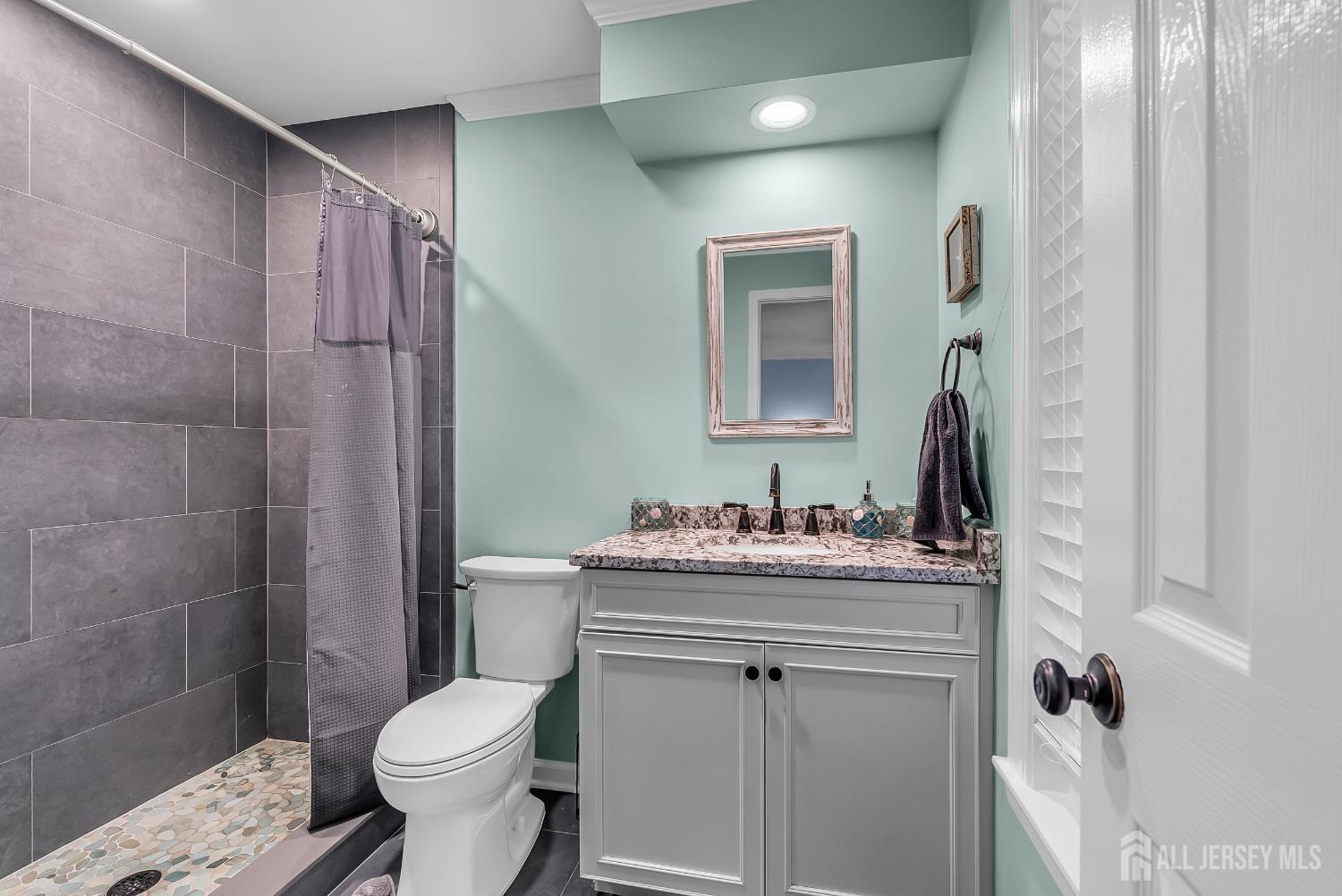 303 Spinnaker Way Neptune, NJ 07753 - Photo 33 of 54 a bathroom with a sink toilet and shower