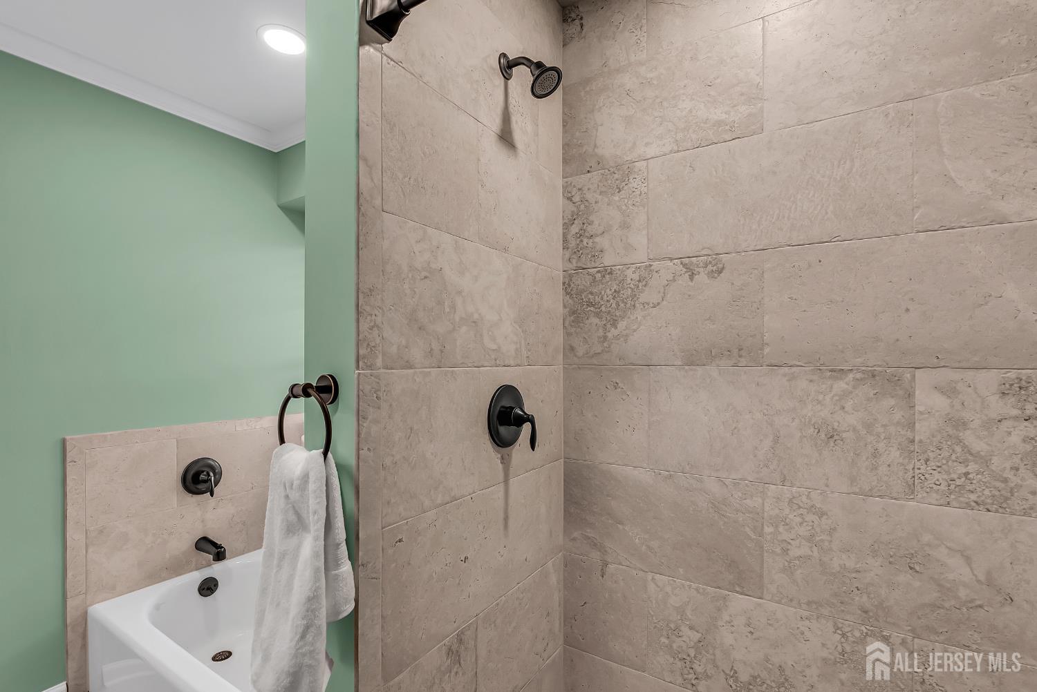 303 Spinnaker Way Neptune, NJ 07753 - Photo 41 of 54 a bathroom with a tub and shower