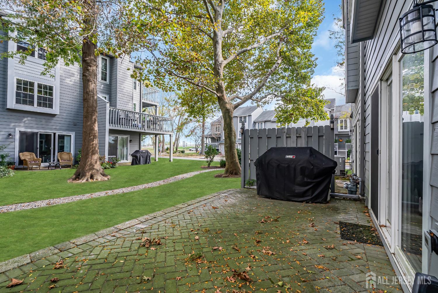 303 Spinnaker Way Neptune, NJ 07753 - Photo 49 of 54 a view of a backyard with table and chairs and a fire pit