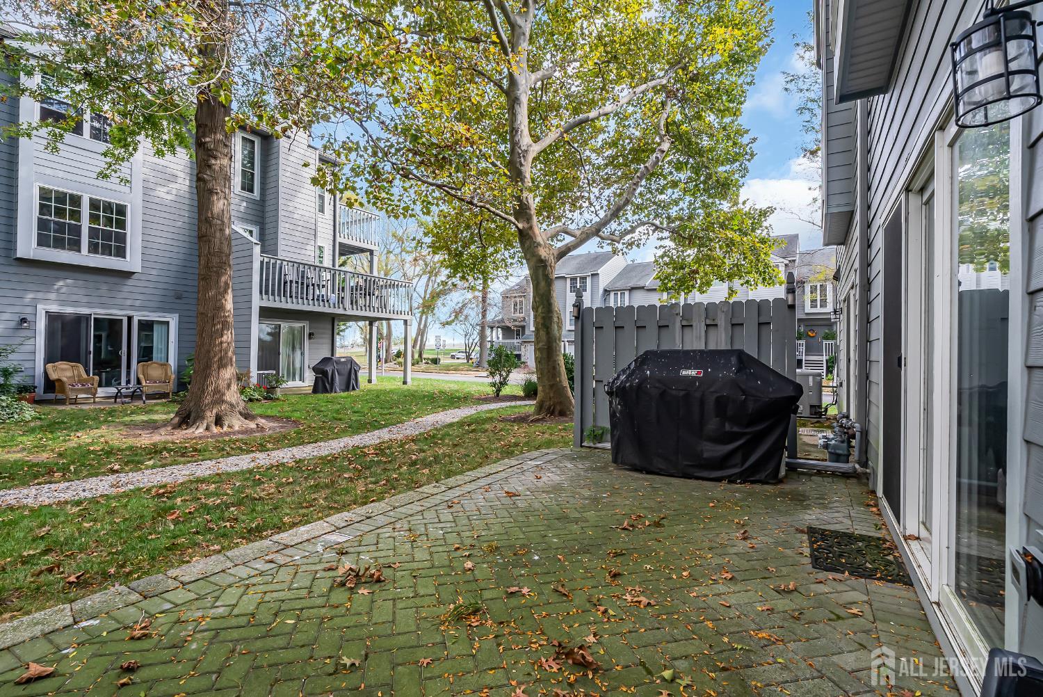 303 Spinnaker Way Neptune, NJ 07753 - Photo 50 of 54 a view of a backyard with table and chairs and a fire pit