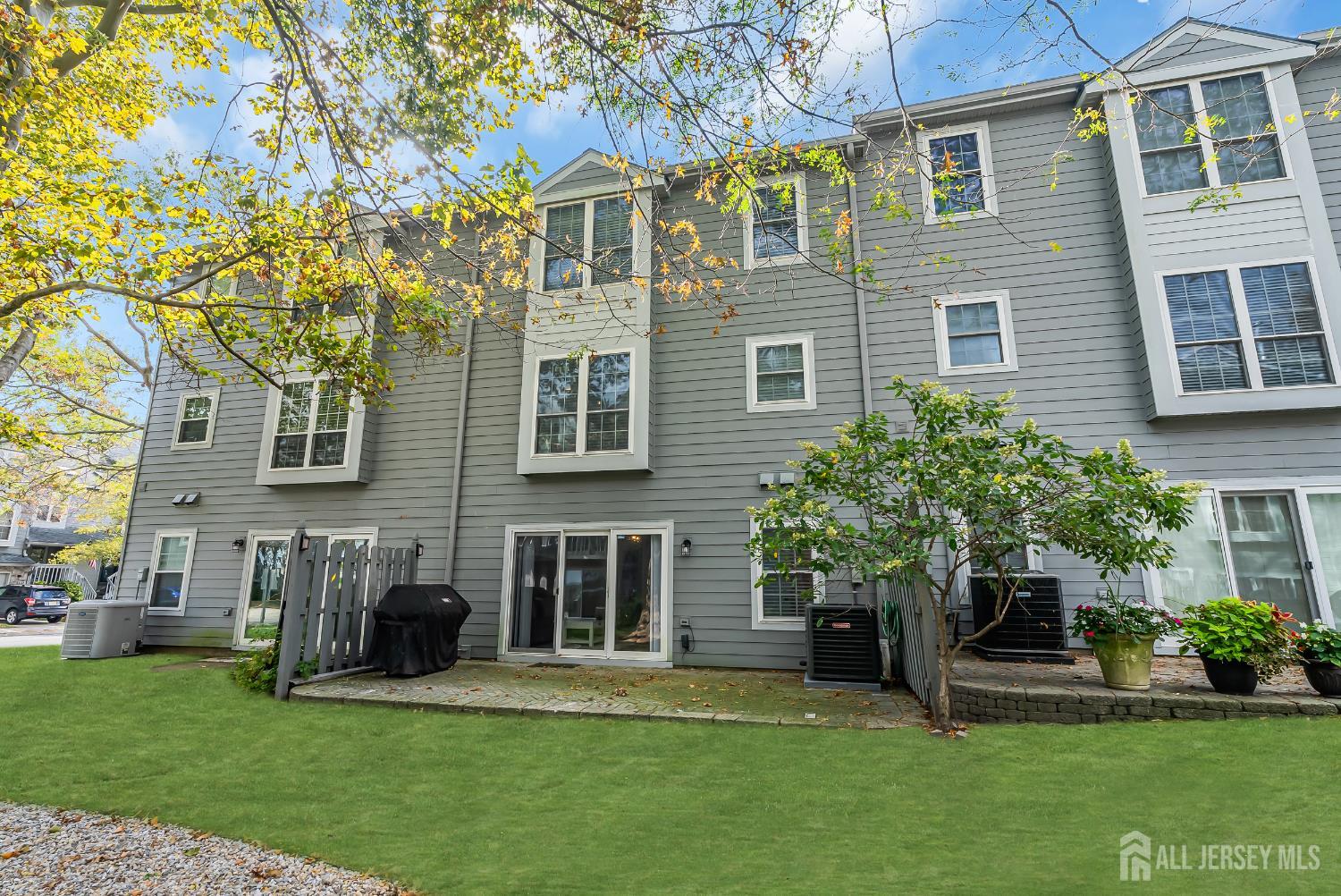 303 Spinnaker Way Neptune, NJ 07753 - Photo 53 of 54 a front view of a house with a garden and plants