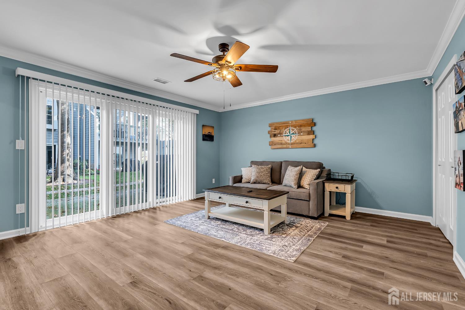303 Spinnaker Way Neptune, NJ 07753 - Photo 7 of 54 a living room with furniture ceiling fan and a window