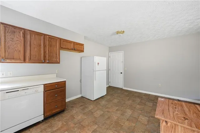 a kitchen with cabinets appliances and a window