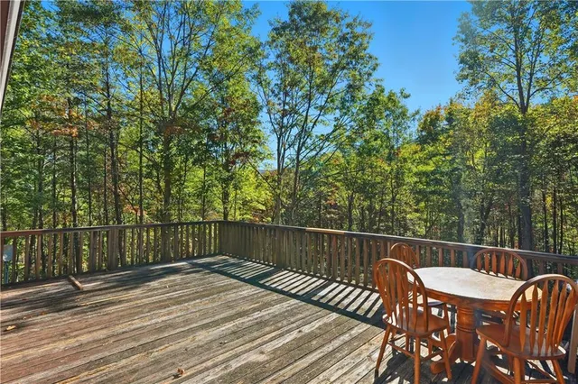 a view of a wooden deck and a backyard